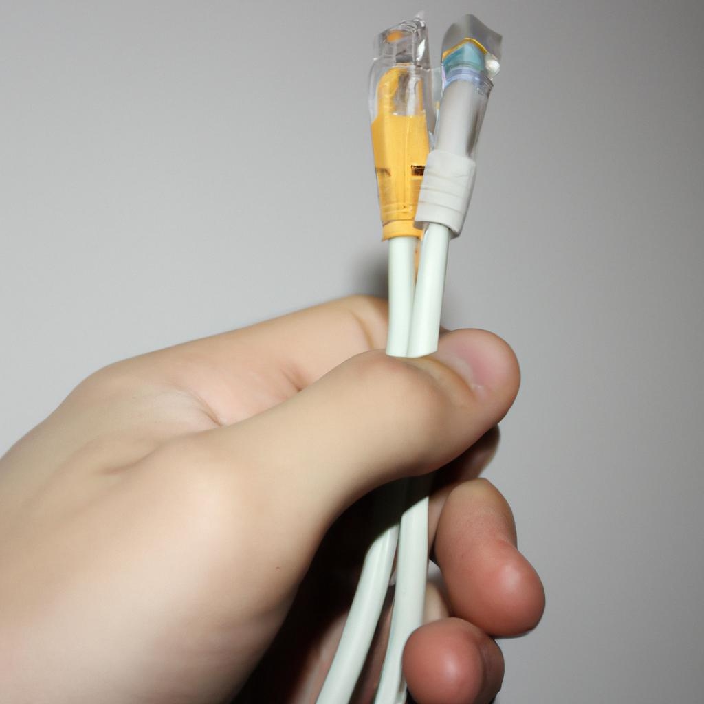 Person holding a network cable